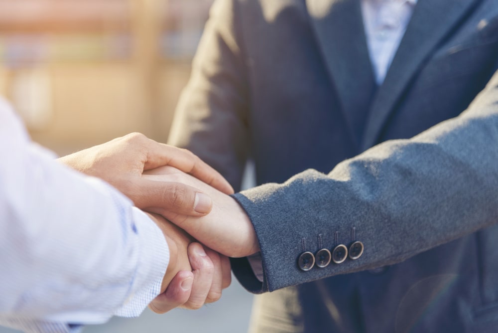 Photo of People Shaking Hands